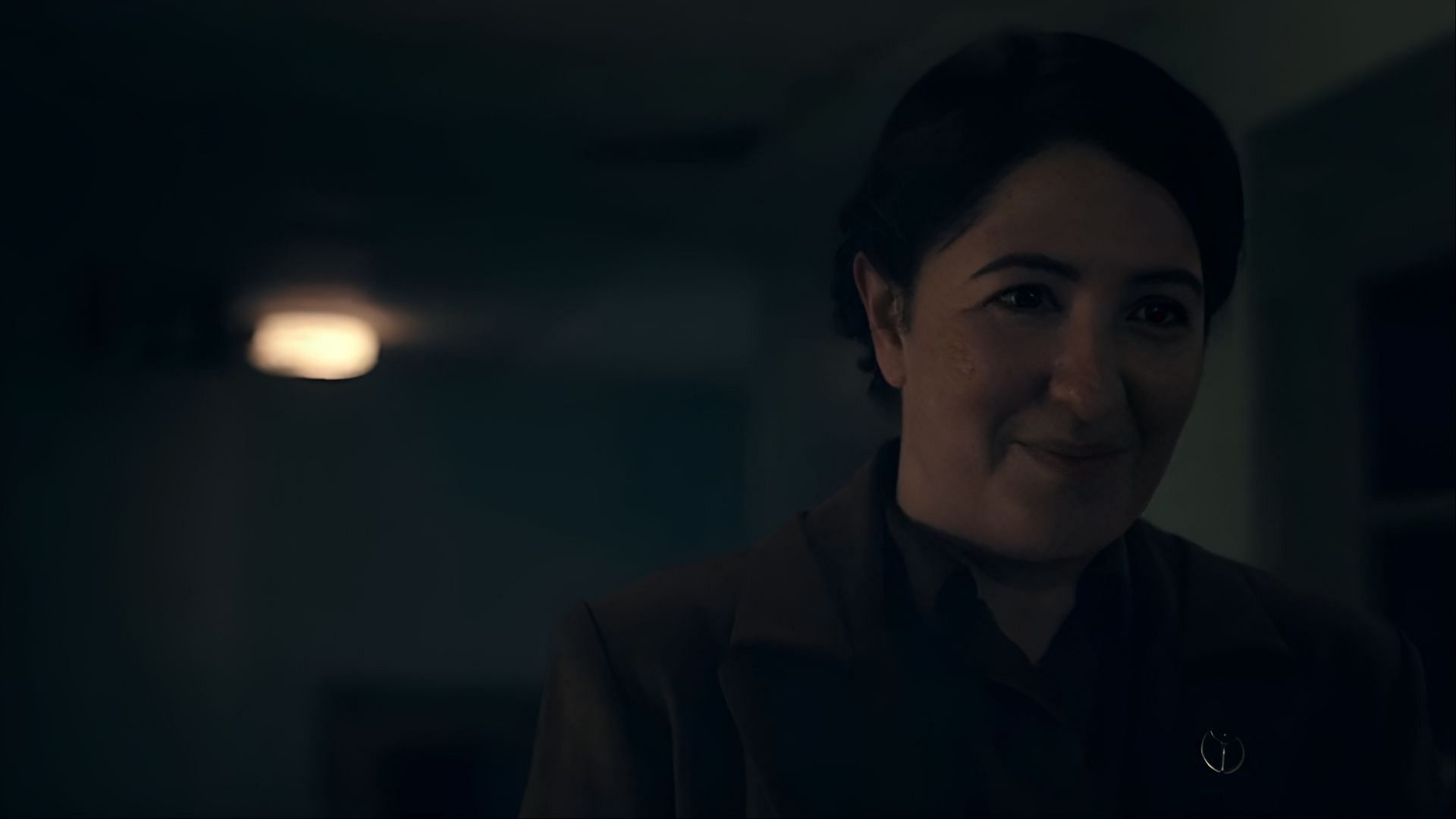 A rare flicker of a smile crosses Aunt Phoebe’s face, adding nuance to her complex role in The Handmaid's Tale. (Image via Hulu)
